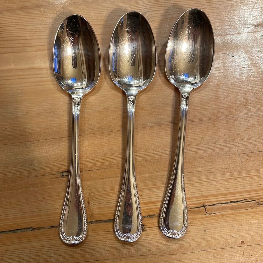 Three Christofle Malmaison silverplate large spoons.